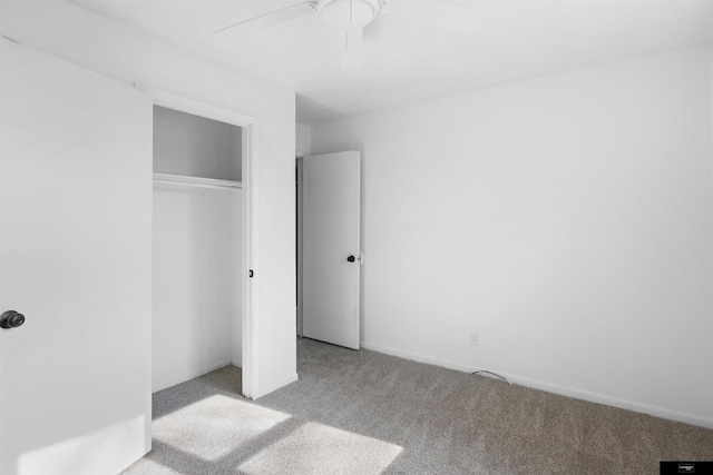 unfurnished bedroom featuring light colored carpet, a closet, and ceiling fan