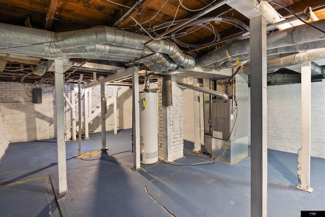 basement featuring heating unit and water heater