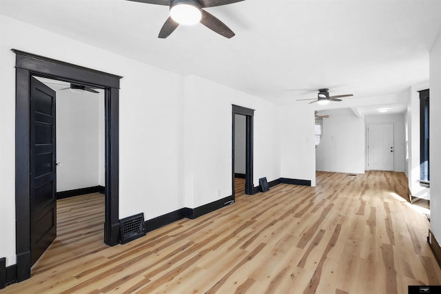 spare room with ceiling fan and light wood-type flooring