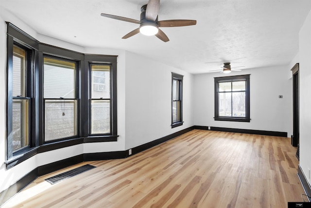 unfurnished room featuring light hardwood / wood-style flooring and ceiling fan