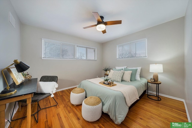 bedroom with ceiling fan and light hardwood / wood-style floors