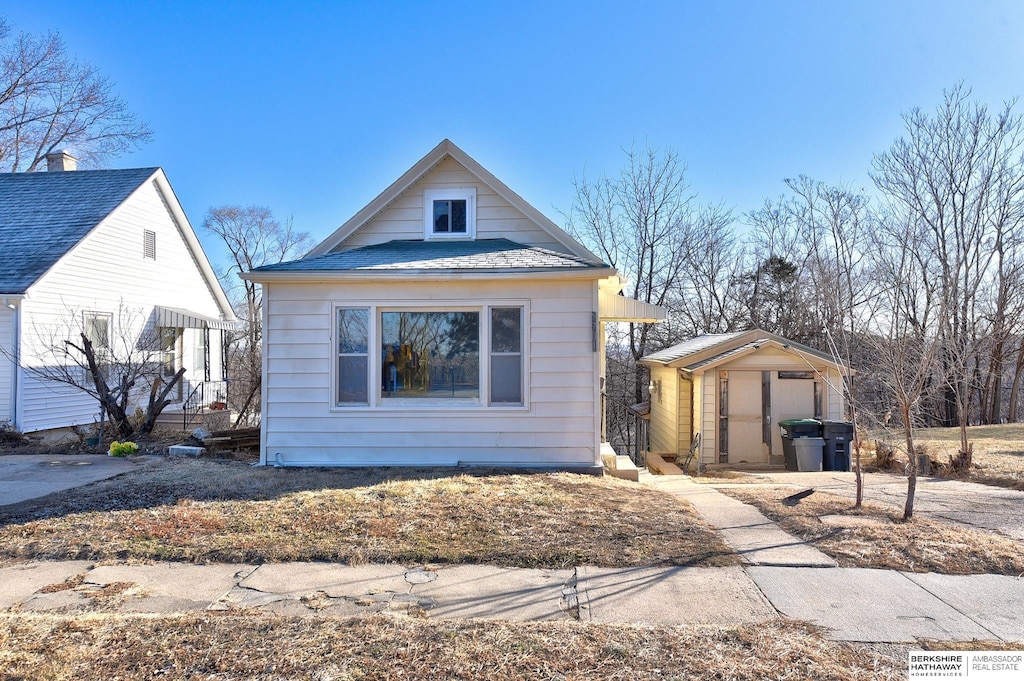 bungalow-style home featuring a storage shed