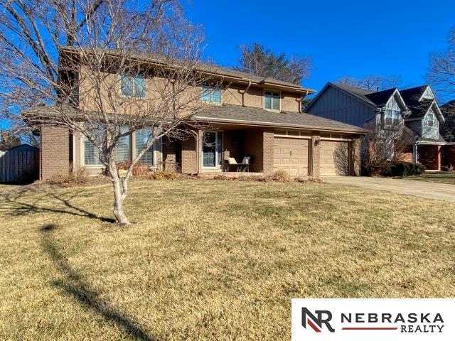 view of front of property featuring a garage and a front lawn