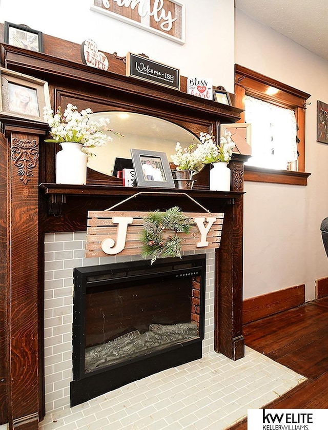 interior details with hardwood / wood-style flooring, a fireplace, and a textured ceiling