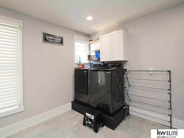 room details with separate washer and dryer and a textured ceiling