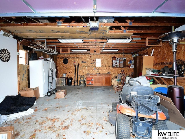 garage featuring a garage door opener and white fridge