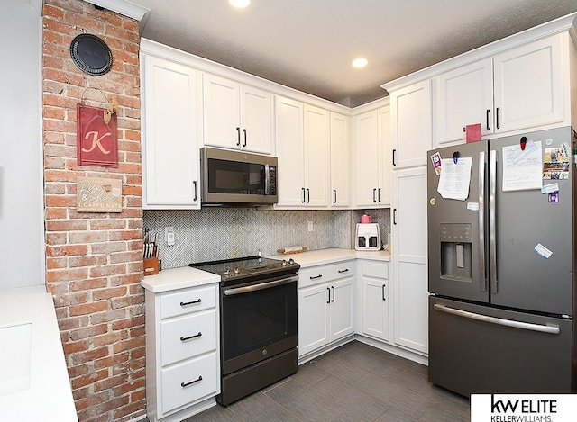 kitchen featuring white cabinetry, appliances with stainless steel finishes, dark hardwood / wood-style floors, and decorative backsplash