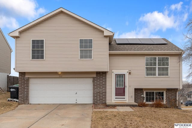 view of front of home with a garage and solar panels