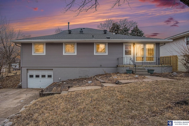 view of front of home featuring a garage and a yard