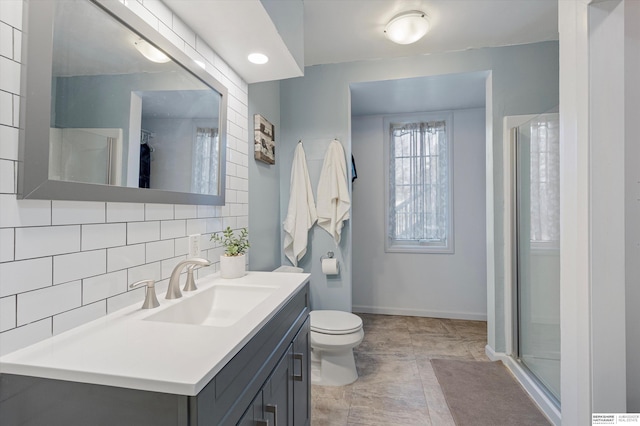 bathroom with walk in shower, vanity, toilet, and backsplash