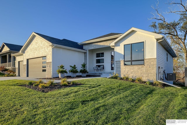 contemporary house with cooling unit, a garage, and a front yard