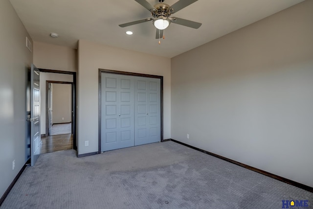 unfurnished bedroom with a ceiling fan, carpet, a closet, and baseboards