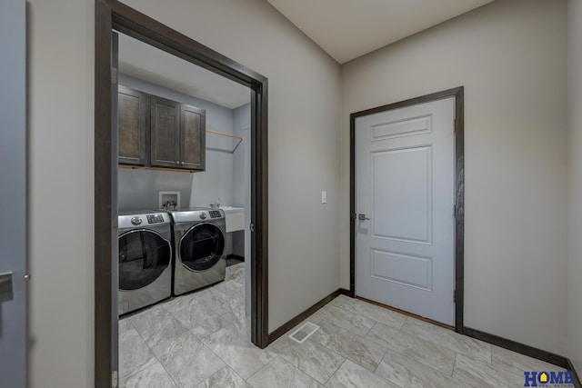 washroom featuring visible vents, independent washer and dryer, cabinet space, and baseboards