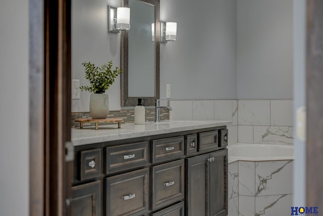 bathroom featuring a bath and vanity