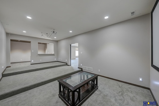 unfurnished living room featuring carpet floors, recessed lighting, and visible vents