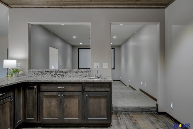 bathroom with recessed lighting, vanity, baseboards, and wood finished floors