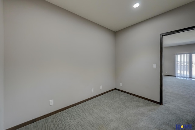 spare room featuring recessed lighting, carpet flooring, and baseboards