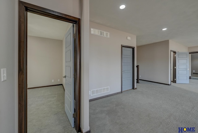 interior space with recessed lighting, visible vents, baseboards, and light colored carpet