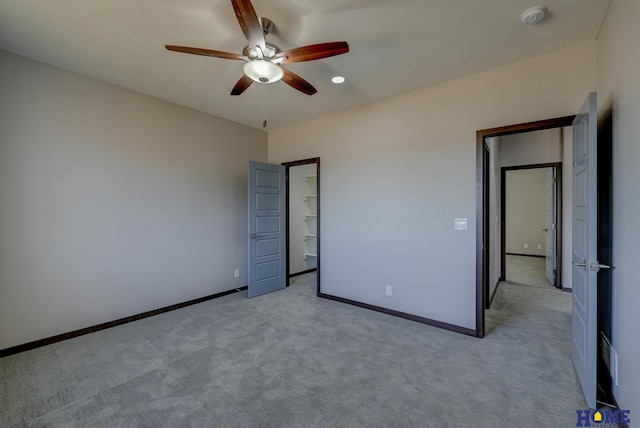 unfurnished bedroom with light carpet, ceiling fan, and baseboards