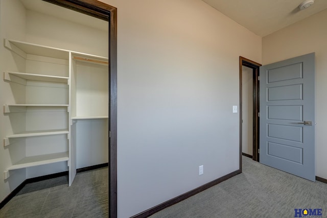 unfurnished bedroom featuring a closet, carpet flooring, and baseboards