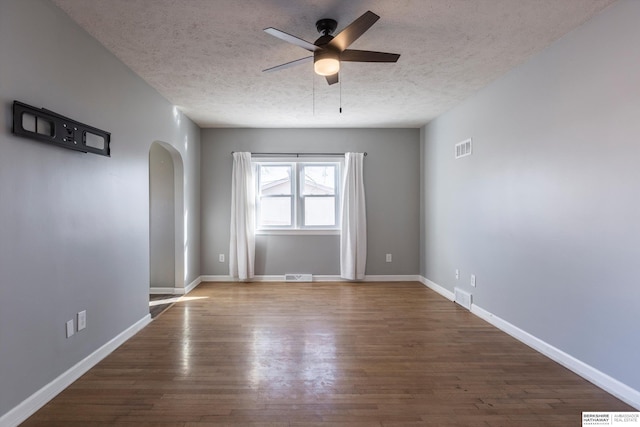 spare room with hardwood / wood-style flooring, a textured ceiling, and ceiling fan