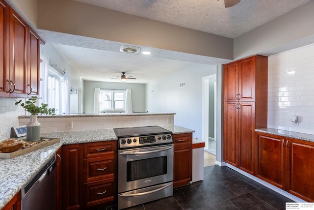 kitchen with tasteful backsplash, a textured ceiling, ceiling fan, stainless steel appliances, and light stone countertops