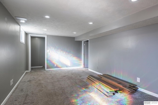 carpeted spare room with a textured ceiling