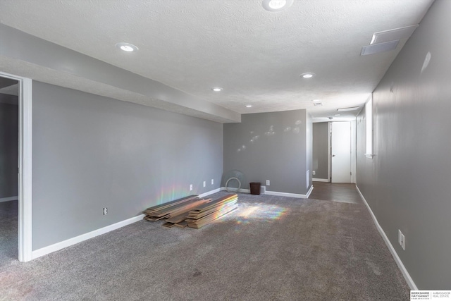 carpeted spare room with a textured ceiling