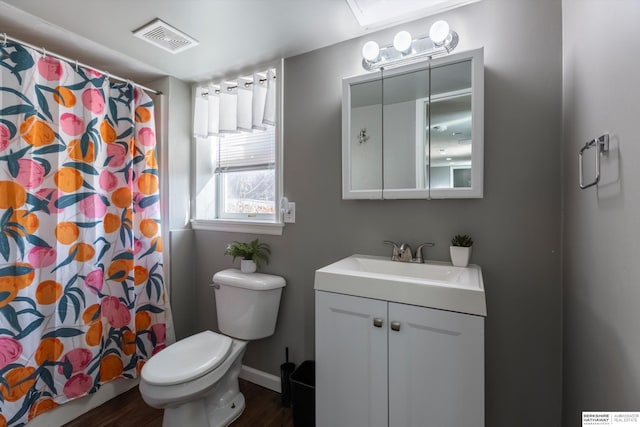 bathroom featuring hardwood / wood-style flooring, vanity, toilet, and walk in shower