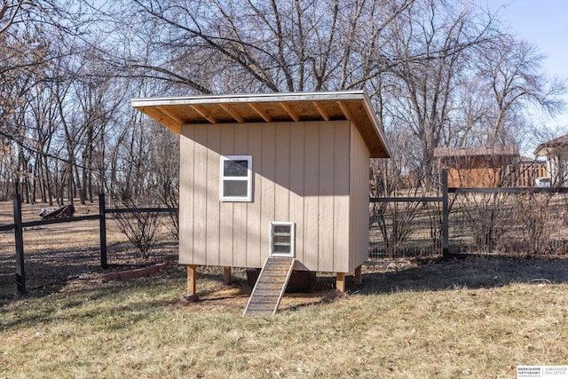 view of outbuilding with a yard