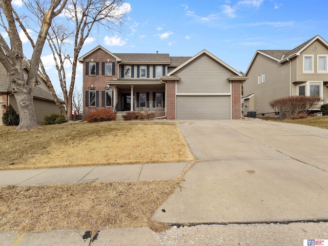 view of front of house with central AC, a garage, and covered porch