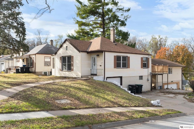 view of front of house featuring a garage and a front lawn