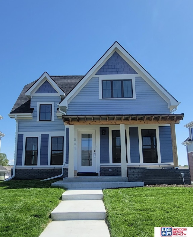 view of front of property with a porch and a front yard