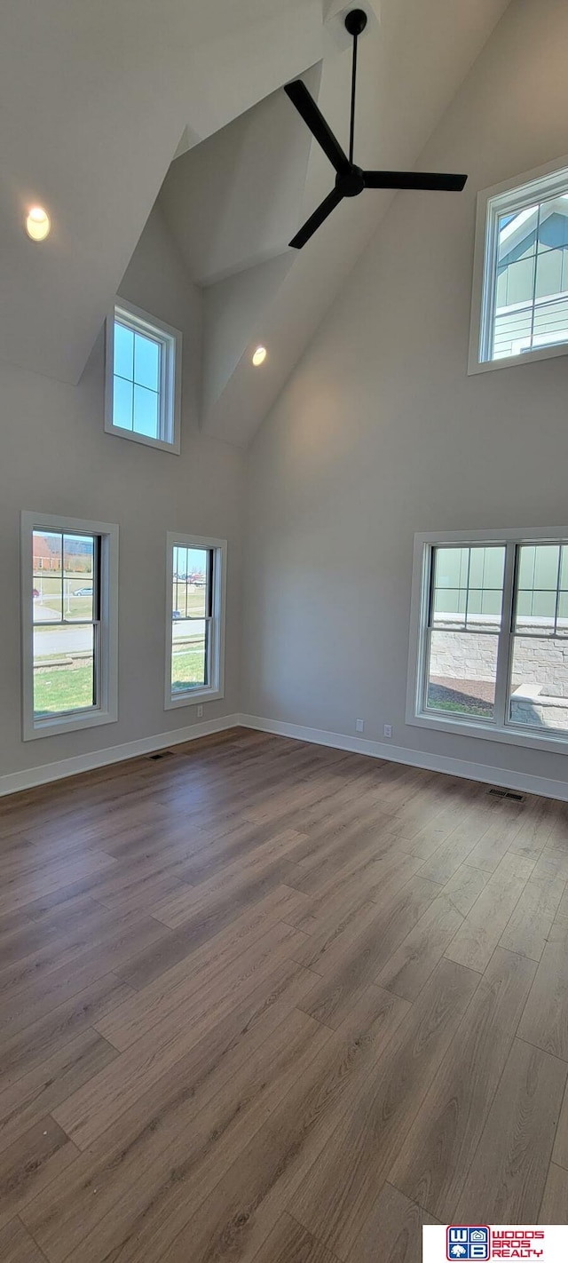 interior space featuring high vaulted ceiling, ceiling fan, and light wood-type flooring