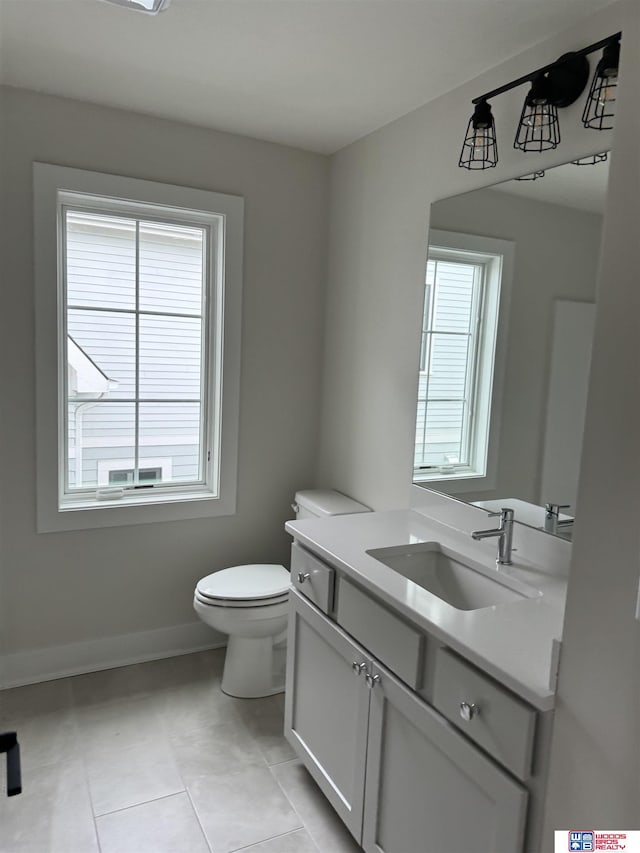 bathroom featuring vanity, tile patterned floors, and toilet