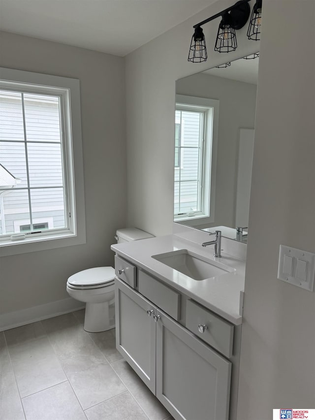 bathroom with vanity, tile patterned floors, and toilet