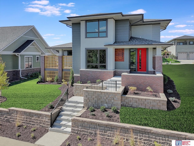 prairie-style home featuring a front lawn