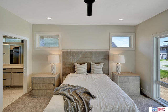 bedroom featuring ensuite bathroom and ceiling fan