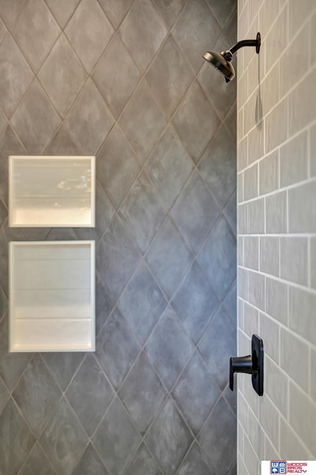 interior details featuring tiled shower