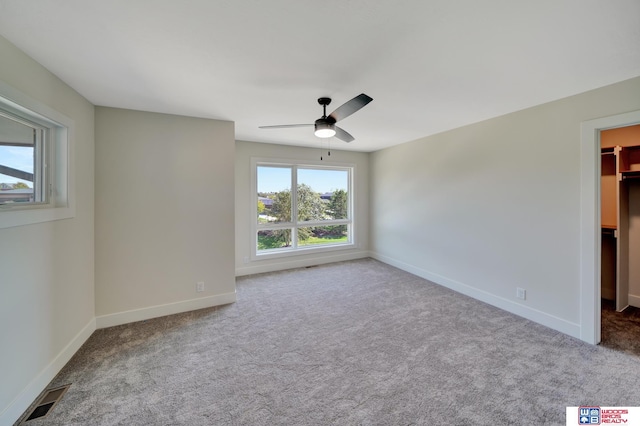 unfurnished room featuring light carpet and ceiling fan