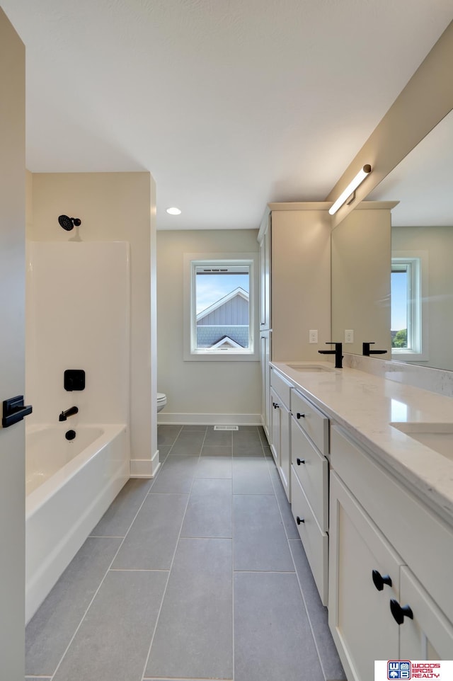 full bathroom featuring vanity, tile patterned flooring, plenty of natural light, and toilet