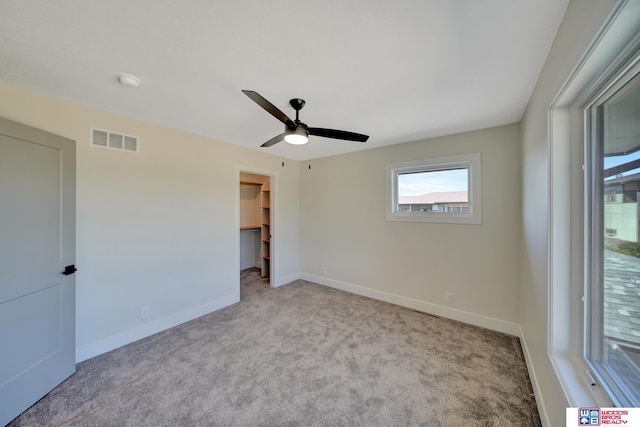 spare room with light carpet and ceiling fan