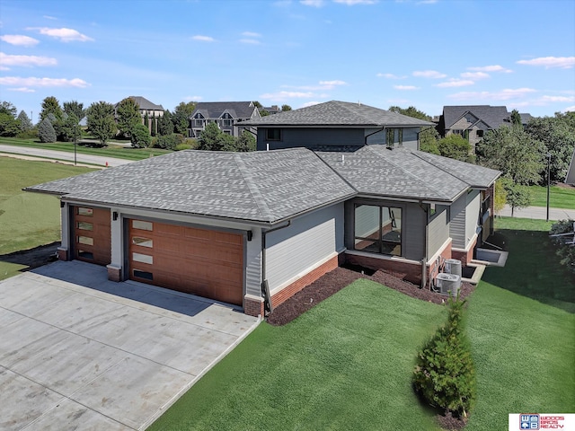 view of front of home featuring a garage and a front lawn