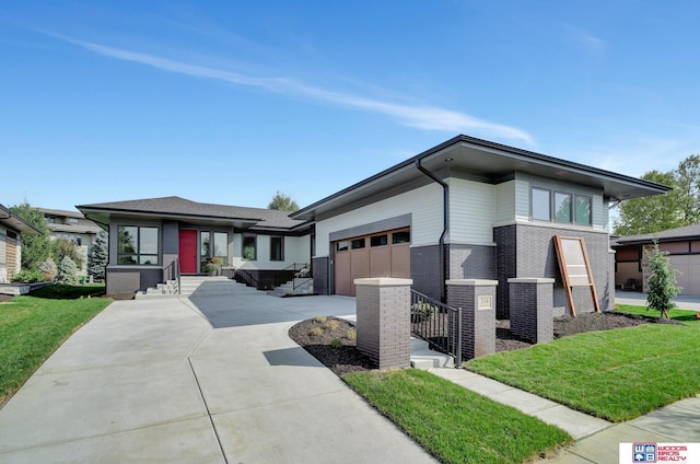 prairie-style house featuring brick siding, concrete driveway, a garage, cooling unit, and a front lawn