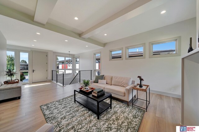 living room with light wood finished floors, baseboards, beamed ceiling, and recessed lighting