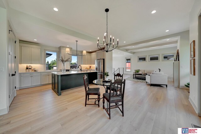 dining area with plenty of natural light, light wood-type flooring, and recessed lighting