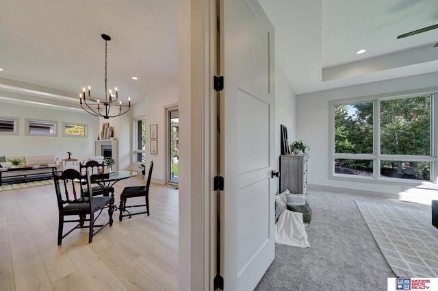 dining space with baseboards, light wood-type flooring, an inviting chandelier, and recessed lighting