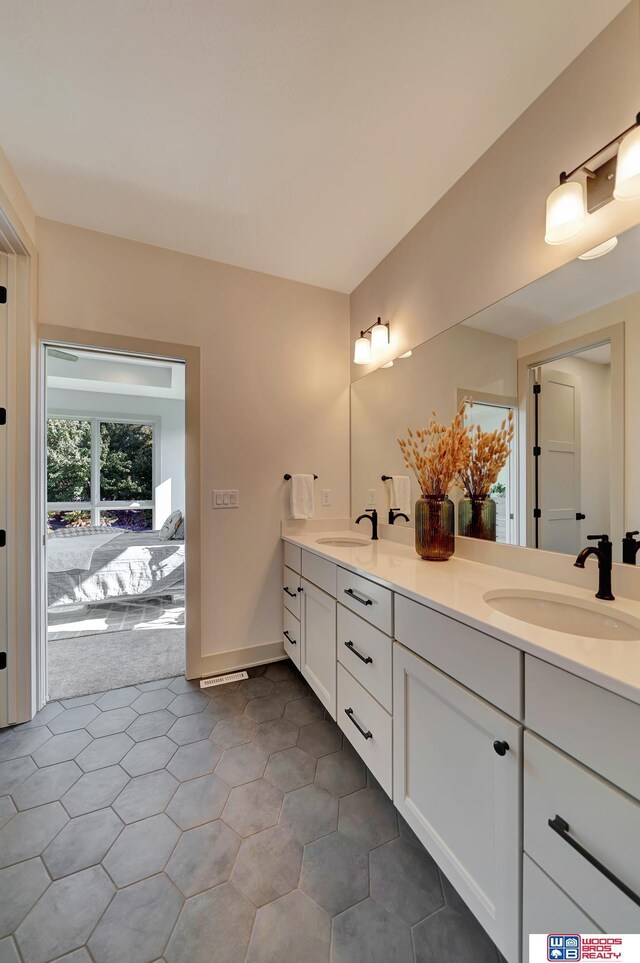 bathroom featuring a sink and double vanity