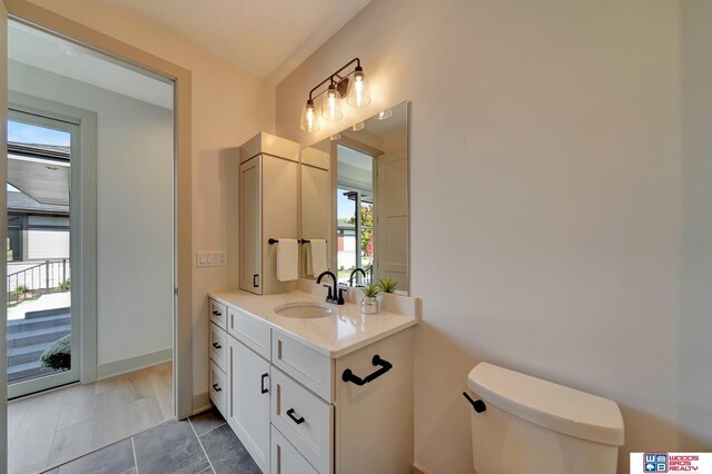 bathroom with toilet and vanity