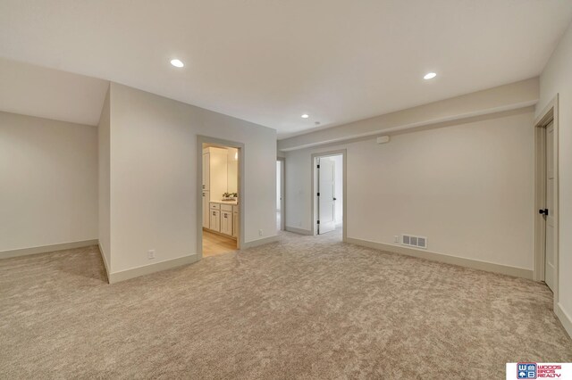 unfurnished bedroom featuring baseboards, light colored carpet, visible vents, and recessed lighting